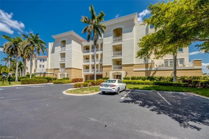 View of property featuring uncovered parking