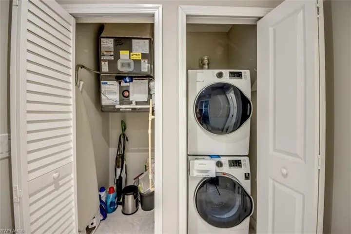Washroom featuring laundry area and stacked washer and clothes dryer