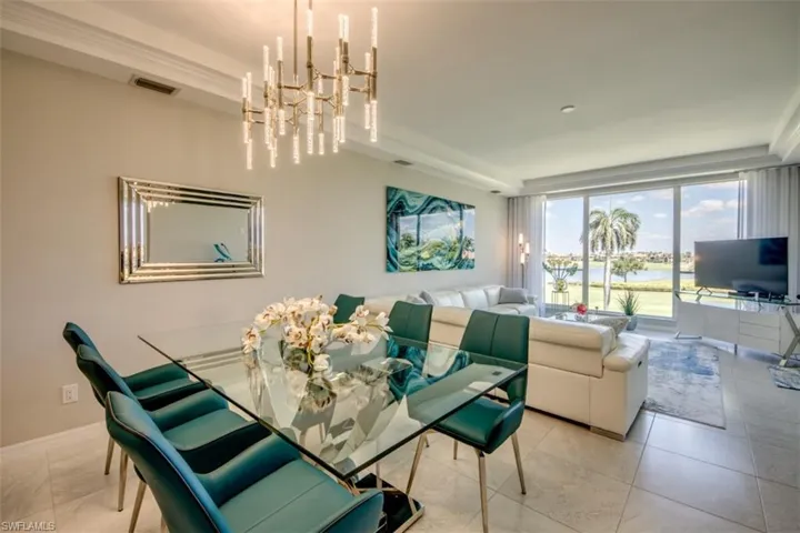 Dining area featuring a chandelier, visible vents, and light tile patterned flooring