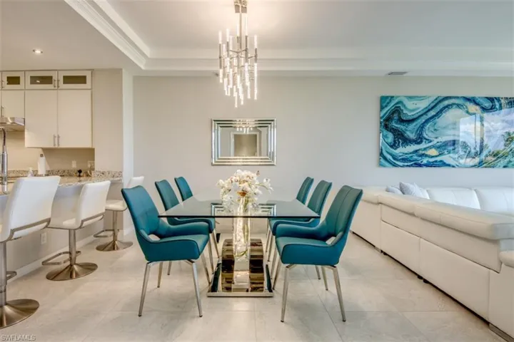 Dining space with an inviting chandelier, ornamental molding, recessed lighting, visible vents, and a raised ceiling