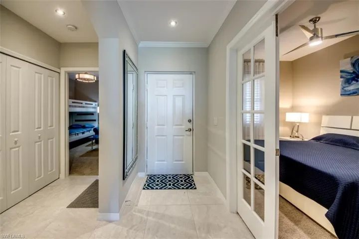 Foyer featuring recessed lighting, french doors, baseboards, and ornamental molding