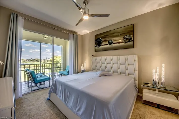 Bedroom with access to outside, carpet flooring, and ceiling fan