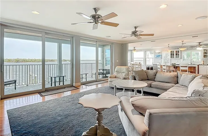Living room featuring plenty of natural light, ornamental molding, recessed lighting, wood finished floors, and a ceiling fan