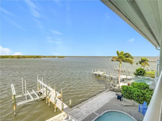 Dock area featuring boat lift and a water view