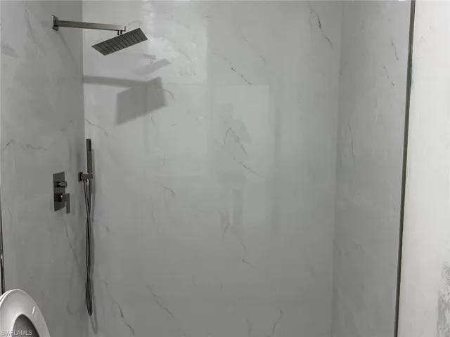 Full bathroom featuring a marble finish shower