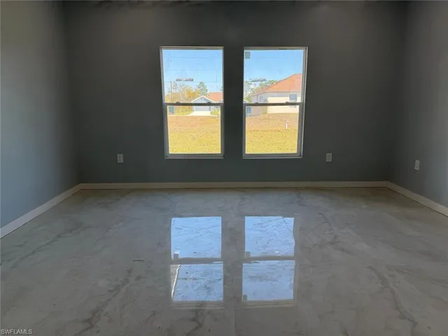 Unfurnished room with baseboards