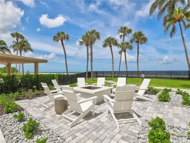 View of patio / terrace with an outdoor fire pit and a water view
