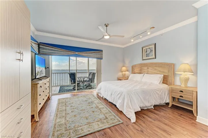 Bedroom with crown molding, access to outside, light wood-type flooring, rail lighting, and a ceiling fan