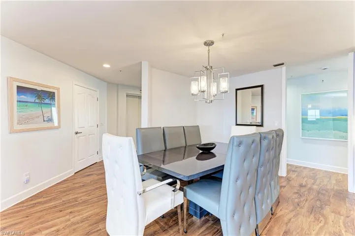 Dining space with light wood-style flooring and a chandelier