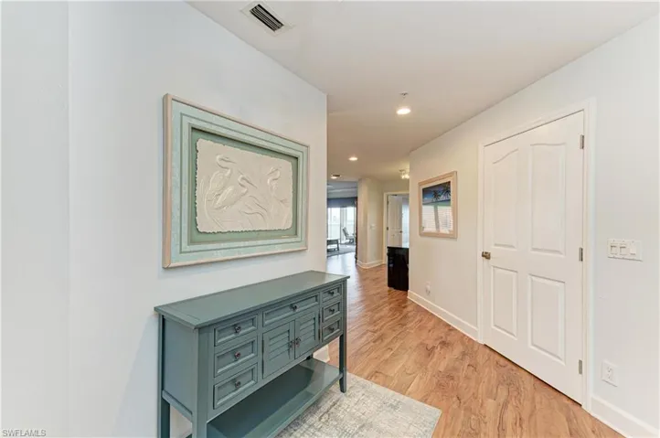 Corridor with light wood-style floors and recessed lighting