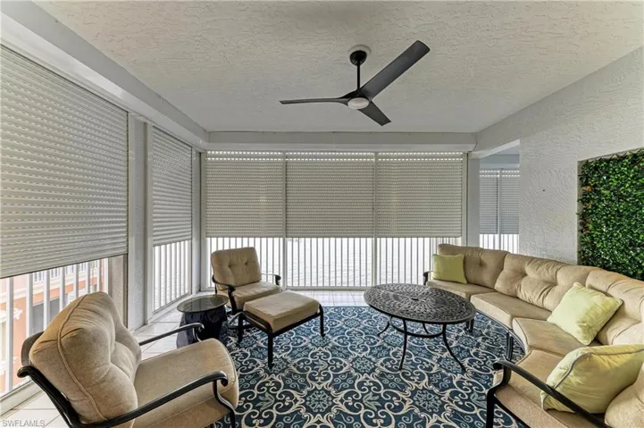 Sunroom / solarium with a textured ceiling and a textured wall