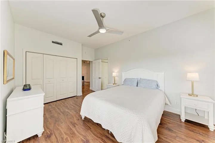 Bedroom with a closet, ceiling fan, and wood finished floors