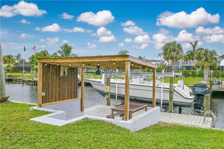 Dock area featuring a water view and a yard