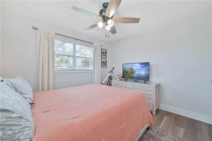 Bedroom featuring hardwood / wood-style flooring and ceiling fan