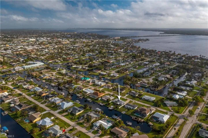Birds eye view of property with a view of the home and the Caloosahatchee River