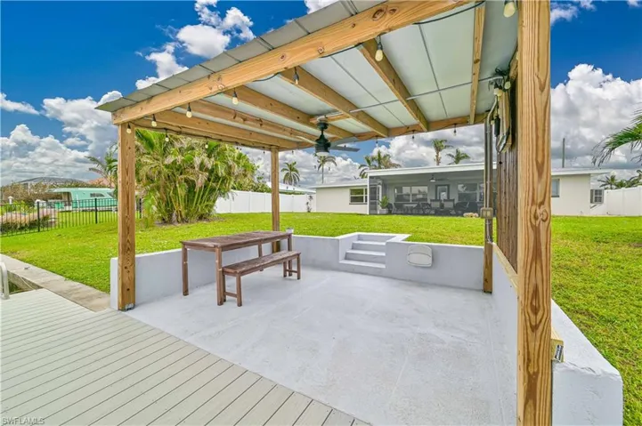 View of patio with ceiling fan and a sunroom, hook up for TV