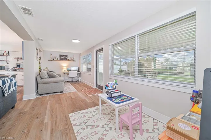 Living room with light wood-type flooring