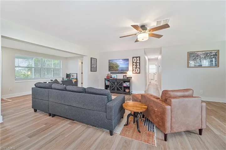 Living room featuring light hardwood / wood-style flooring and ceiling fan