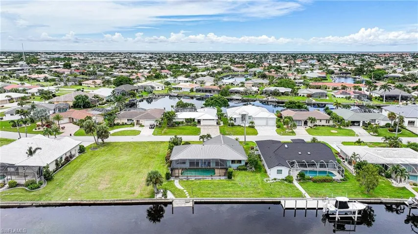 Aerial perspective of suburban area with a nearby body of water