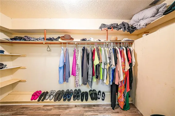 Walk in closet featuring wood finished floors
