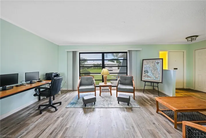 Office featuring ornamental molding, wood finished floors, and a textured ceiling
