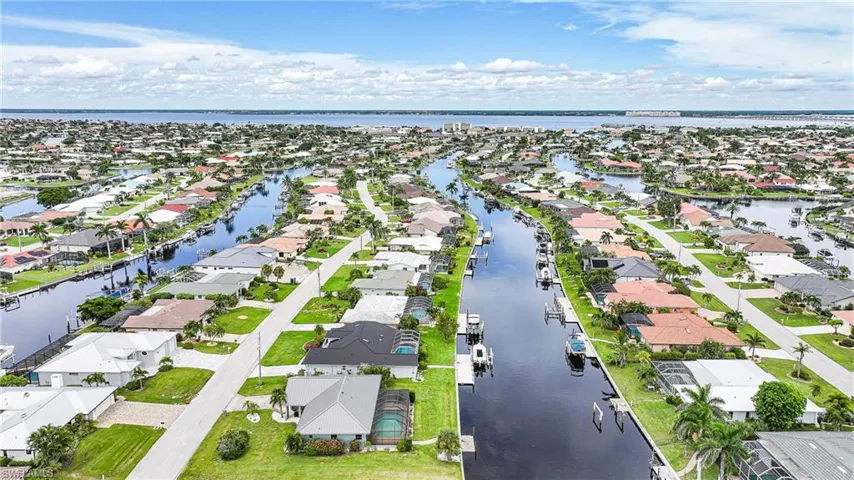 Aerial view of residential area featuring a large body of water