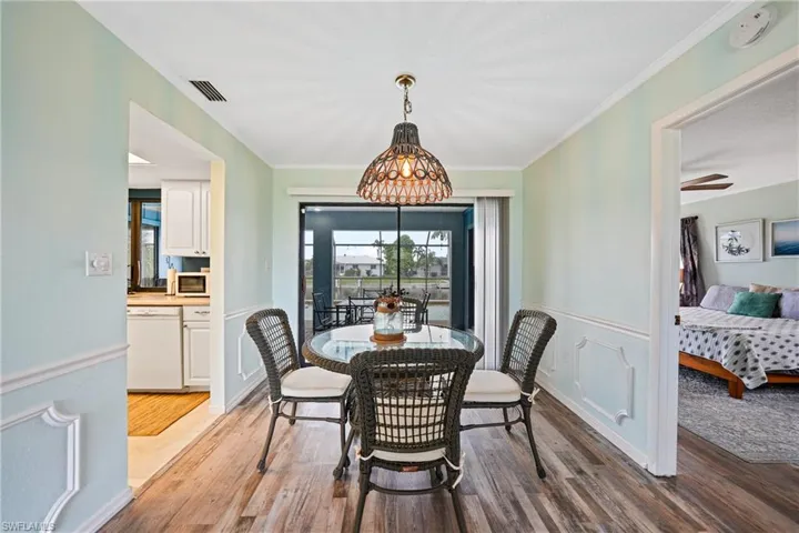 Dining room featuring crown molding, wood finished floors, and ceiling fan