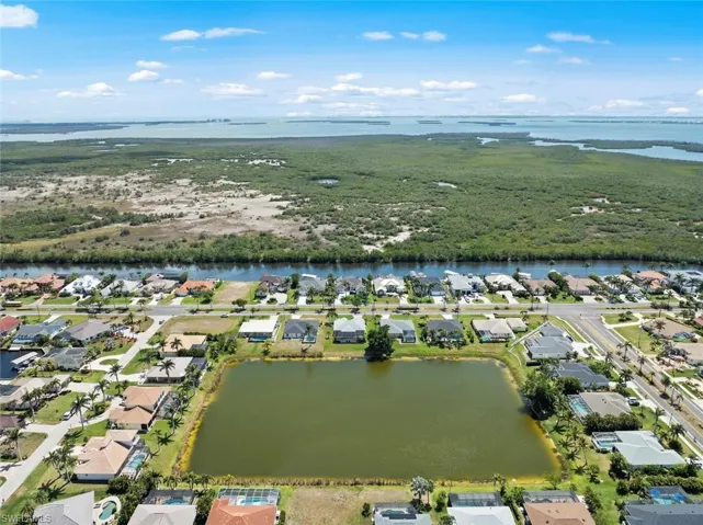 Drone / aerial view with a residential view and a water view