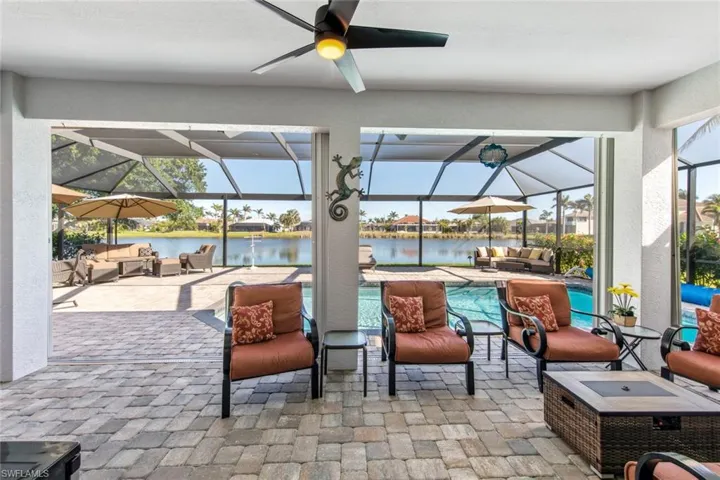 View of patio featuring an outdoor pool, an outdoor hangout area, a lanai, a water view, and ceiling fan