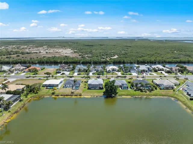 Drone / aerial view with a water view and a residential view