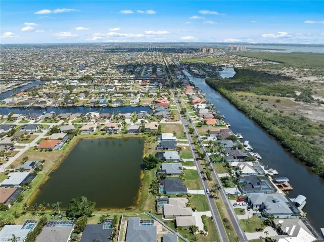 Drone / aerial view with a residential view and a water view