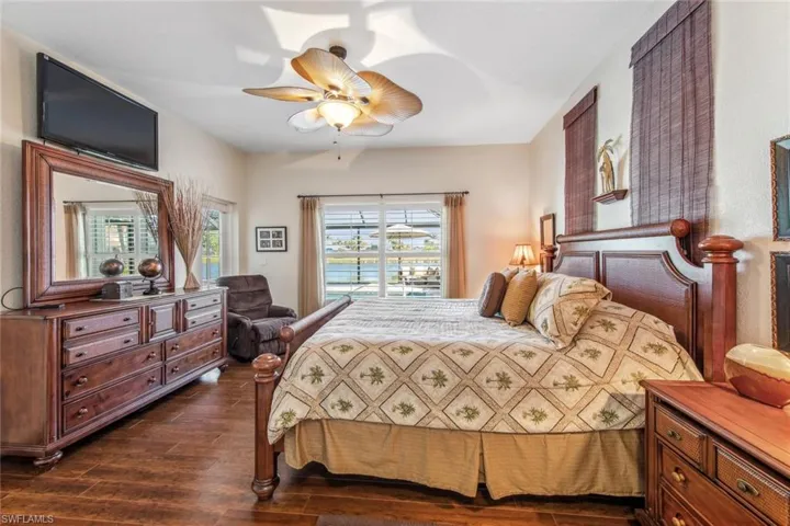 Bedroom featuring dark wood-type flooring and ceiling fan