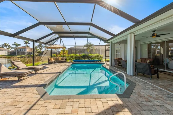 Pool featuring an outdoor living space, ceiling fan, a patio, and a lanai