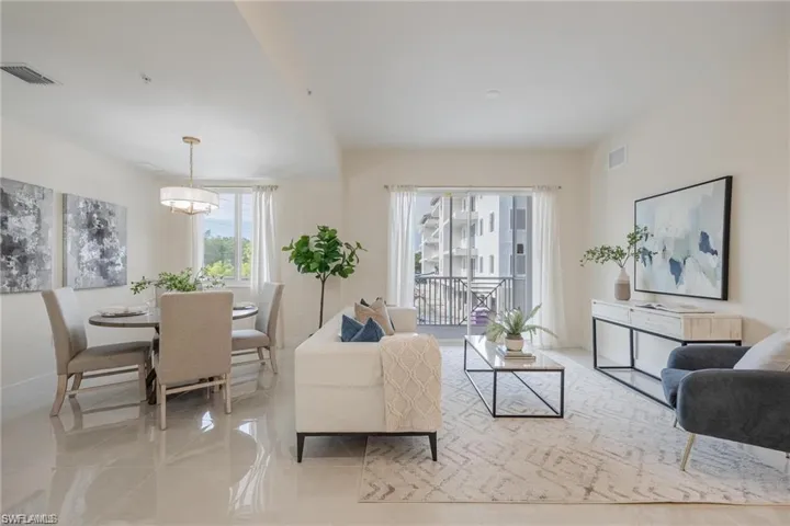 Living area with baseboards, visible vents, and light tile patterned floors