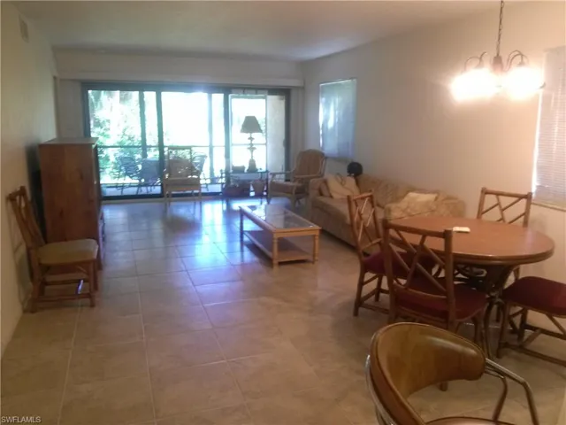 Tiled dining area with an inviting chandelier