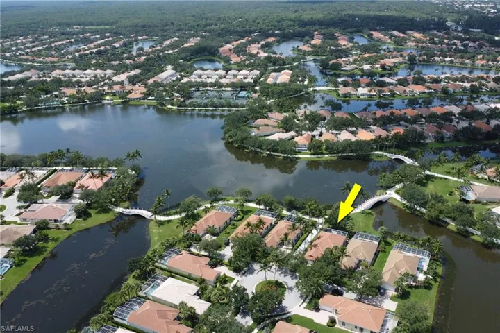 Aerial view of property and surrounding area with nearby suburban area
