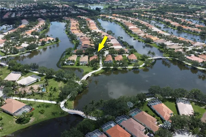 Aerial view of property and surrounding area with nearby suburban area and a nearby body of water
