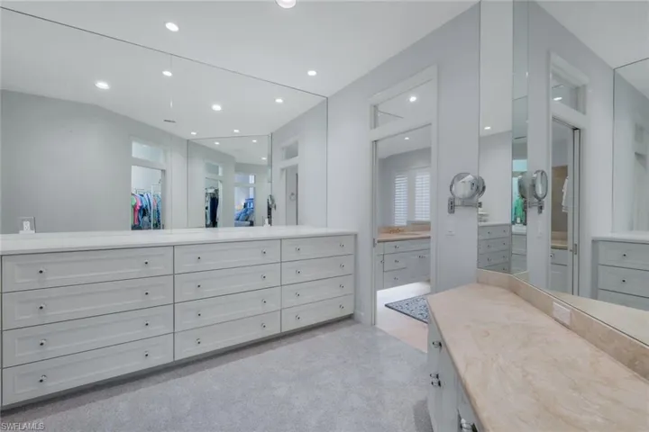 Dressing room and vanity area between bedroom and bath.