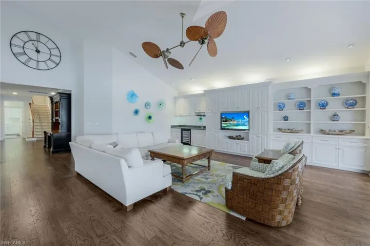 The large living area features built-in shelving, cabinetry and a wet-bar!