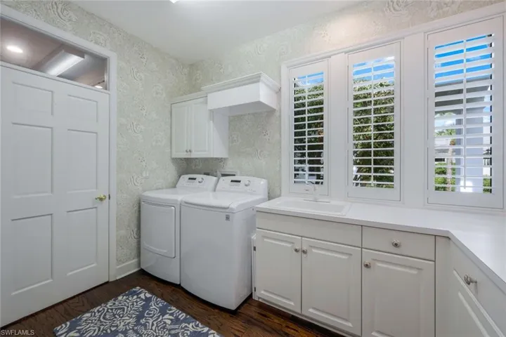 Laundry room with an abundance of countertop and cabinet space.