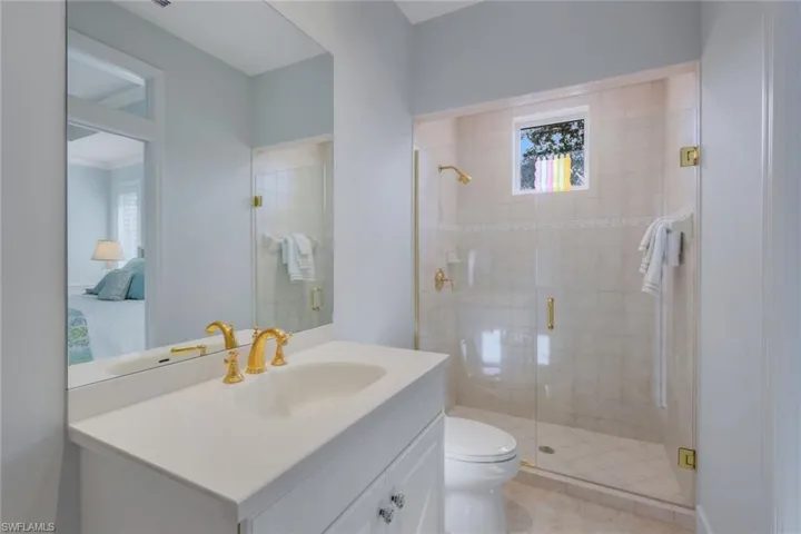 Frameless shower featuring floor to ceiling tile.