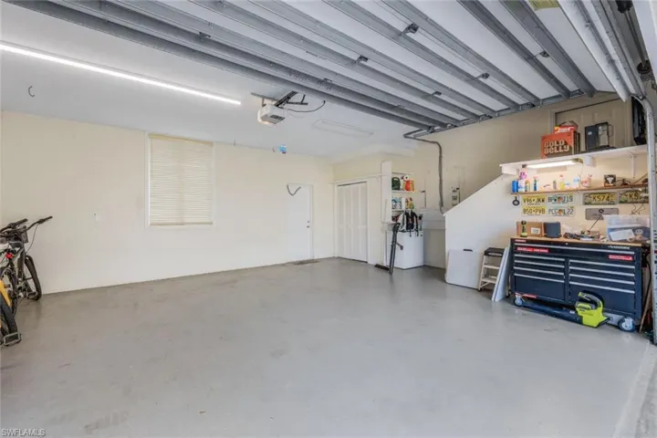 Oversized two car garage with storage closet and space for a work bench.