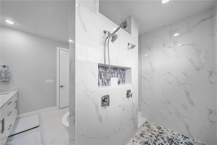 Bathroom with vanity and a tile shower