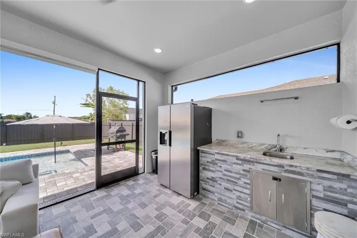 Kitchen with sink and stainless steel fridge