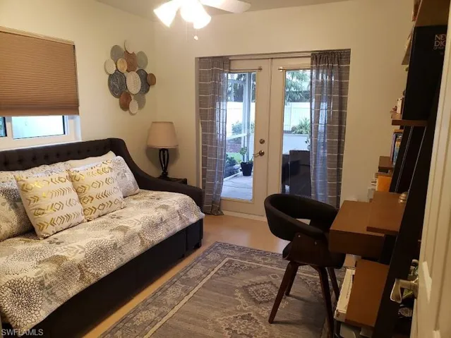 Bedroom featuring access to outside, french doors, and multiple windows