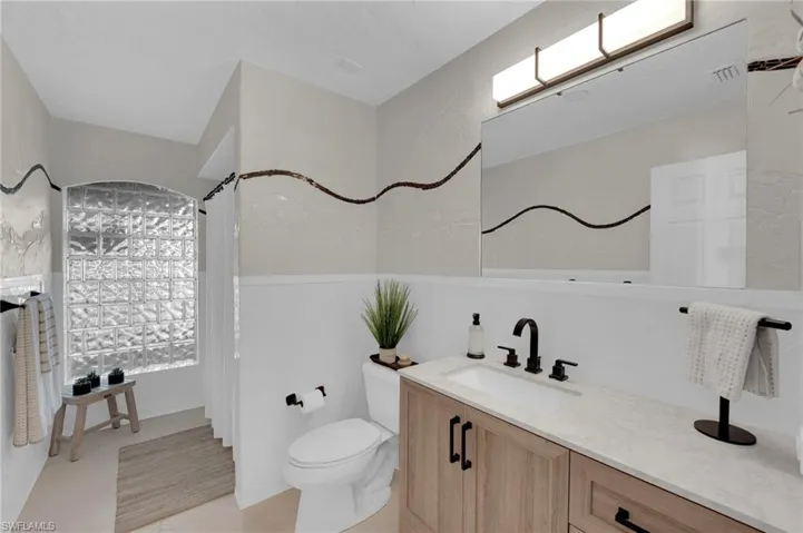 Full bath with vanity and curtained shower