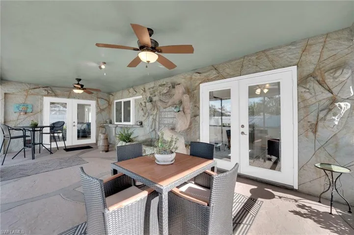 View of patio / terrace featuring french doors, a ceiling fan, and outdoor dining space