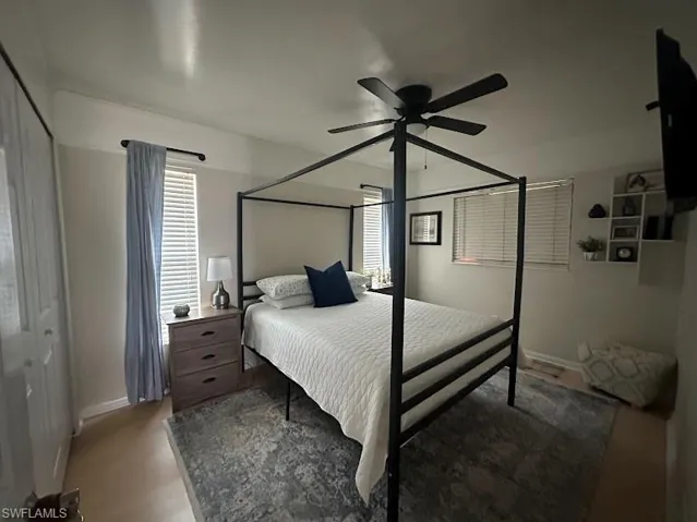 Bedroom with a ceiling fan and baseboards