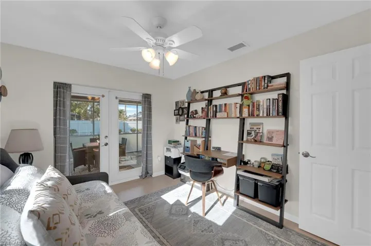 Office space featuring french doors, a ceiling fan, and wood finished floors
