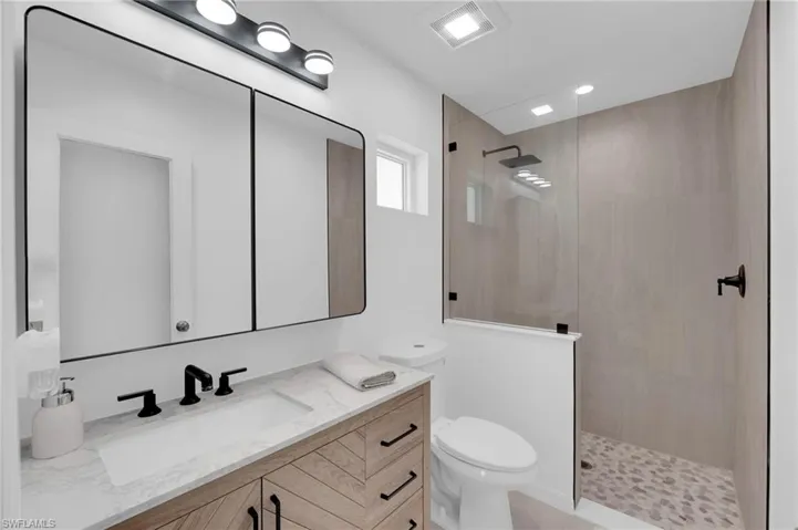 Full bathroom with vanity and a walk in shower